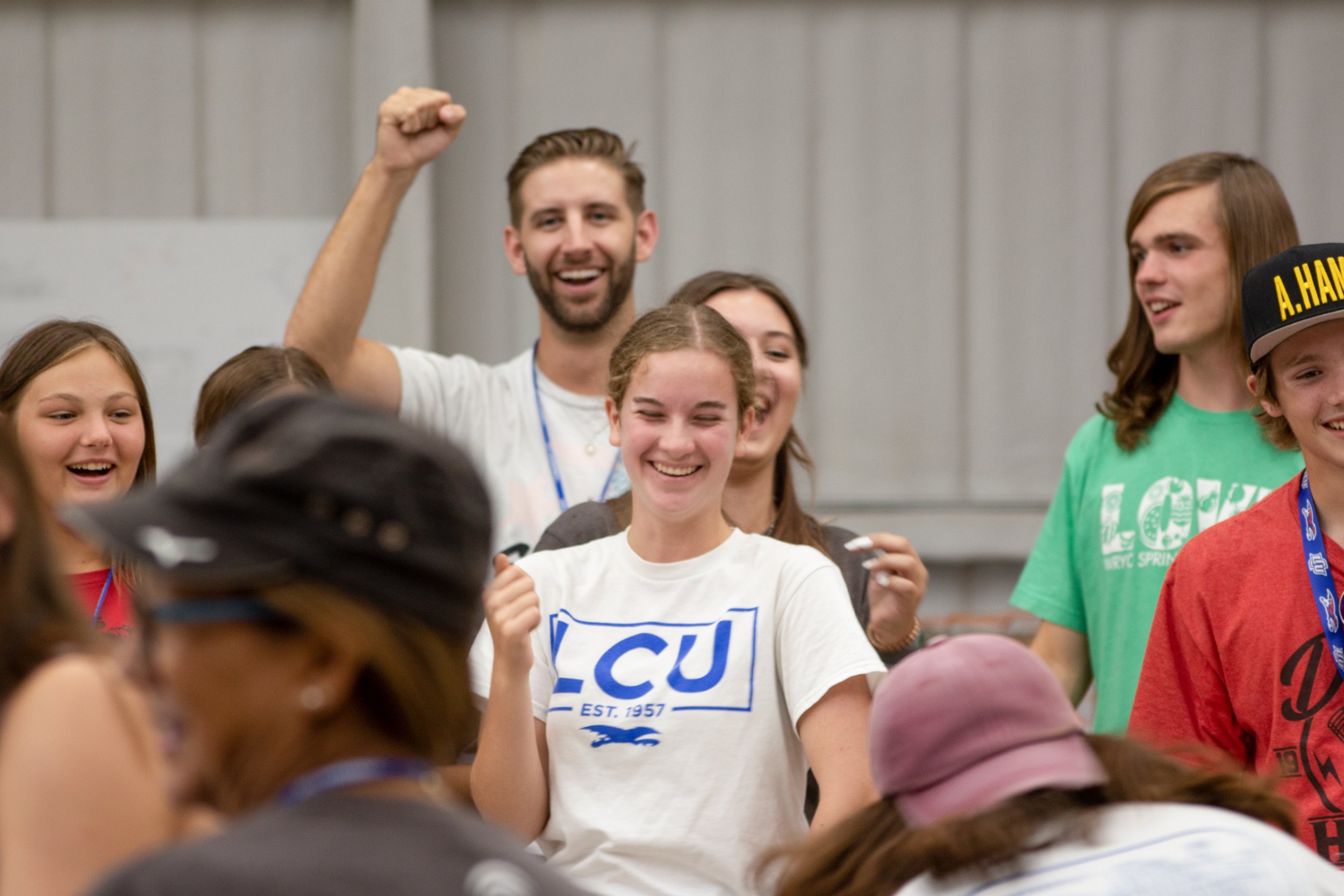 A group of students cheering for one student wearing an LCU t-shirt