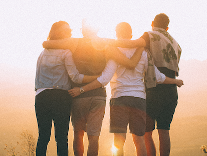 Four people looking at sunrise