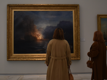 Two women admiring painting