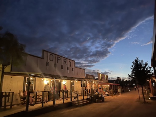 White River Youth Camp Western Street, with people on porches during the evening