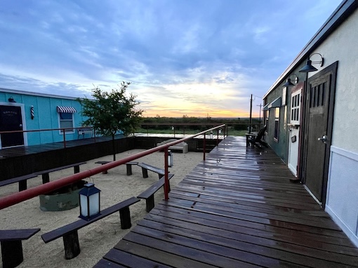 Porches outside of camp buildings at sunset after a rain