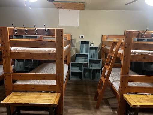 One of the bunk rooms showing two bunk beds and storage